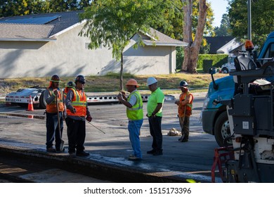 Northridge, California / USA -  September 25, 2019: L.A. Road Construction Crew Supervisors Having A Discussion At The Work Site Planning Out The Repaving Operation