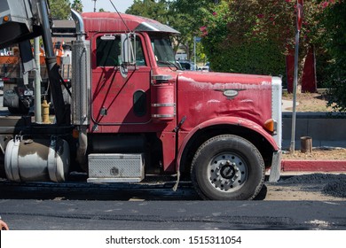 Northridge, California / USA -  September 25, 2019: Classic Peterbilt Logo With Truck Center Underneat, On The Hood Of A Dump Truck With Rust And Dent Damage At A Work Site.