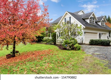 Northwest Horse Ranch White House With Fall Changing Leaves And White Fence.