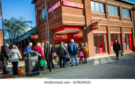 Northwich, Cheshire/Uk March 20th 2020: Shoppers Queuing Outside Iceland Supermarket During The Corona Virus Crisis, Northwich, Cheshire Uk.  