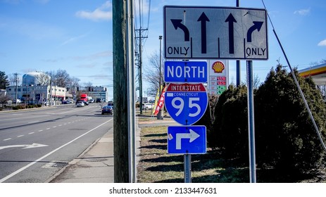 NORWALK, CT, USA - MARCH 8, 2022:  Street signs with Shell gasoline price stand on Post Road.