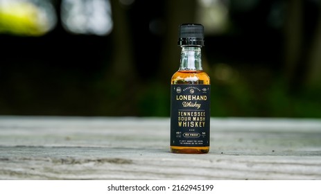 NORWALK,  CT, USA - MAY 29, 2022: Lonehand Tennessee Sour Mash Whiskey In Small Bottle Outside On Table