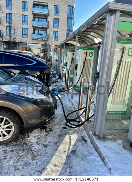 Strømmen, Norway -\
02.06.2021\
\
Electrical cars charging on a charging station\
outside a shopping\
mall.