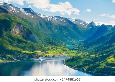 Norway. Cruise ship in the Norwegian fjord. High mountains and reflections on the surface of the water. Clouds over the rocks. Vacation and travel in summer Norway. - Powered by Shutterstock