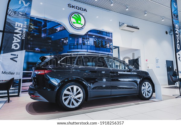 Tønsberg,\
Norway - February 11, 2021: black Skoda enyaq IV is a suv electric\
car. New car in car dealership show\
room.