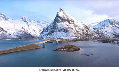 Norway. High-angle view of a serene body of water framed by majestic mountains in the background. The landscape highlights elements such as a glacial lake, snow-capped peaks, and a clear winter sky. - Powered by Shutterstock