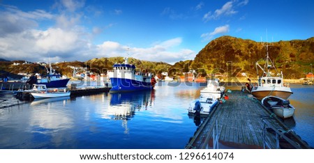 Norway marina with sailboats and fishingboats in a small village in the fjords