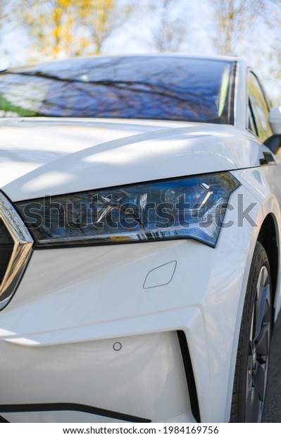 Tønsberg, Norway - may\
15, 2021: white Skoda enyaq IV is a suv electric car. New car in\
car in the\
countryside