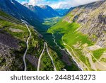  Norway. The serpentine road meanders picturesquely on the green slopes of the canyon.  Trollstigen Norge. Drone filming.