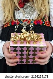 Norwegian Girl Holding Confirmation Gift While Wearing Norwegian National Day Dress. 