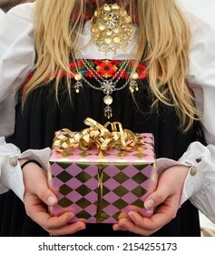 Norwegian Girl Holding Confirmation Gift While Wearing Norwegian National Day Dress. 