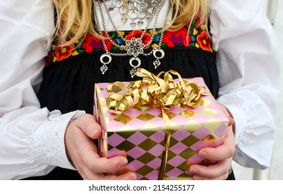 Norwegian Girl Holding Confirmation Gift While Wearing Norwegian National Day Dress. 