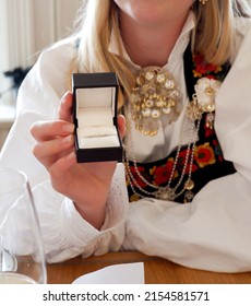 Norwegian Girl Holding Confirmation Gift While Wearing Norwegian National Day Dress. 