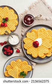 Norwegian heart shaped waffles with sour cream, jam and raspberries.. Waffle day. Scandinavian traditional food. baked waffles