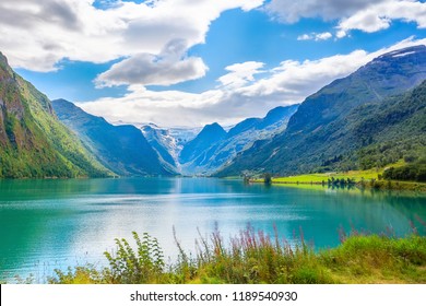 Norwegian landscape with Nordfjord fjord, mountains, flowers and glacier in Olden, Norway