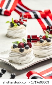 Norwegian national day 17th May. Mini Pavlova cake with flag. Norwegian flag