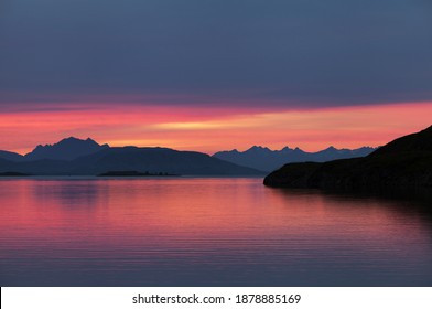 Norwegian Seascape At Night After Sunset, Pink Color Of The Clouds Reflecting On Water Surface. 