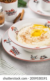 Norwegian Traditional Rice Porridge With Butter And Cinnamon. Milk In The Cup With Santa. Christmas Mood