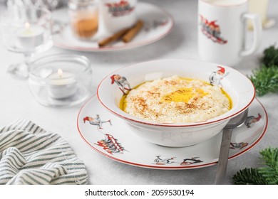 Norwegian Traditional Rice Porridge With Butter And Cinnamon. Milk In The Cup With Santa. Christmas Mood