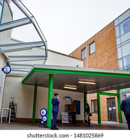 Norwich, Norfolk, UK. 18 May 2019. Candid Photos – A Nurse On Break Talking On Her Mobile Phone At The NHS Norwich University Hospital, Whilst Patients Are Validating Their Car Parking Tickets