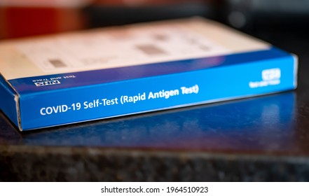 Norwich, Norfolk, UK – April 28 2021. A Close Up Of A Covid 19 Rapid Antigen Home Testing Kit On A Black Work Top With Intentional Selective Focus, Shallow Depth Of Field And Bokeh. 