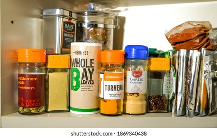 Norwich, Norfolk, UK – December 06 2020. Illustrative editorial photography of the contents of a kitchen cupboard stocked with various spices, herbs, powders, condiments and cooking additives