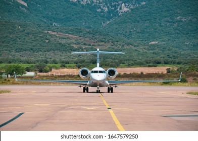 Nose To Nose With A Beautiful Private Business Jet On The Tarmac Of Airport Close To Porto Vecchio. Jet Set Lifestyle During Summertime In The South Of France.