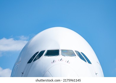 Nose Section Of A Wide Body Airliner Isolated On The Blue Sky In France. This Long Haul Aircraft Is One Of The Biggest In The World. The Cockpit Windows Are Huge On This Airplane