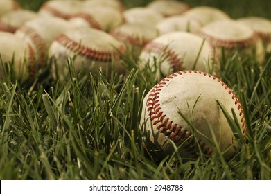 Nostalgic Baseballs In The Grass On A Baseball Field