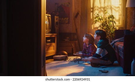 Nostalgic Childhood Concept: Young Brother And Sister Playing Old-School Arcade Video Game On Retro TV Set In A Living Room With Period-Correct Interior. Friends Spend The Day At Home Playing Games.