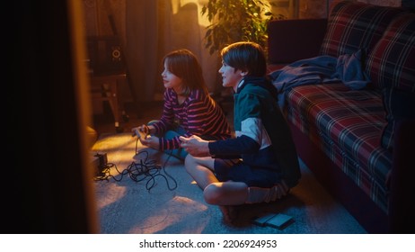 Nostalgic Childhood Concept. Young Brother And Sister Playing Old-School Arcade Video Game On A Retro TV Set In A Living Room With Period-Correct Interior. Friends Spend The Day At Home Playing Games.