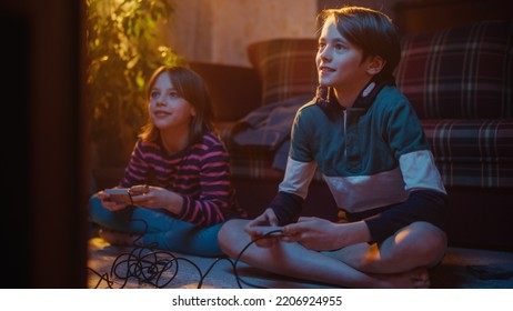 Nostalgic Childhood Concept: Young Brother And Sister Playing Arcade Video Game On A Retro Console In A Living Room With Period-Correct Interior. Friends Spend The Day At Home Playing Games.