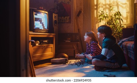 Nostalgic and Happy Childhood Concept: Young Brother and Sister Playing 8 Bit 2D Arcade Video Game on a Retro TV Set at Home in a Room with Period-Correct Interior. Friends Completing the Level. - Powered by Shutterstock