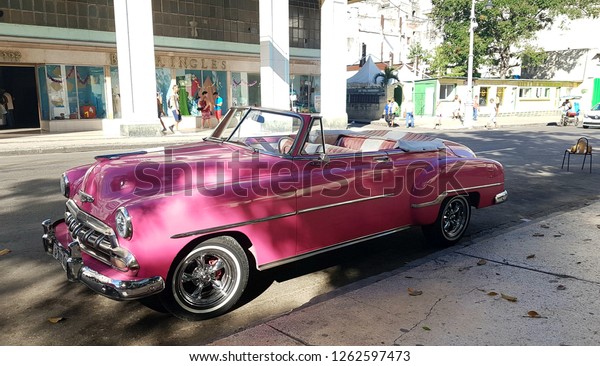 Nostalgic old pink Cuban cars. La Habana,\
Center / Cuba -\
12.03.2018