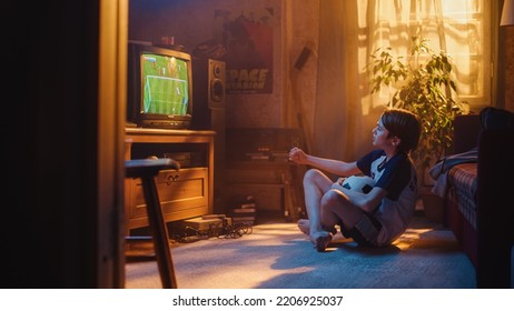 Nostalgic Retro Childhood Concept. Young Boy Watches A Soccer Match On TV In His Room With Dated Interior. Supporting His Favorite Football Team, Getting Excited When Players Score A Goal.