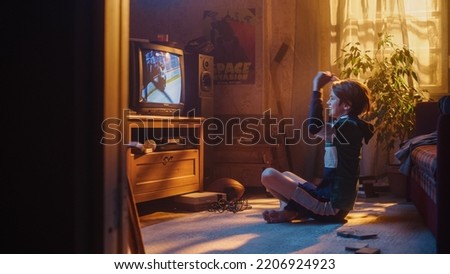 Nostalgic Retro Childhood Concept. Young Boy Watches Hockey Match on TV in His Room with Dated Interior. Supporting His Favorite Team and Getting Excited When Players Score a Goal.