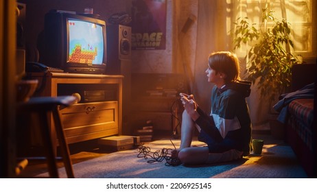 Nostalgic Retro Concept: Young Boy Playing Old-School Eighties Arcade Video Game on a Console at Home in His Room with Period-Correct Interior. Successful Kid Passes the Level and Wins.