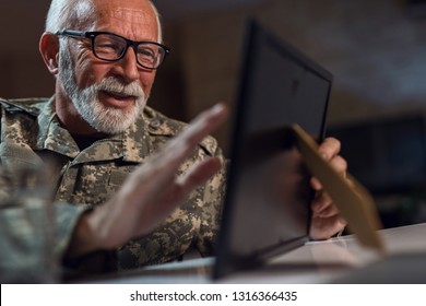 Nostalgic Senior Veteran Recalling The Memories And Looking At Picture In Photo Frame. 