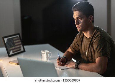 Nostalgic US Army Soldier Feeling Home Sick While Writing A Letter. 