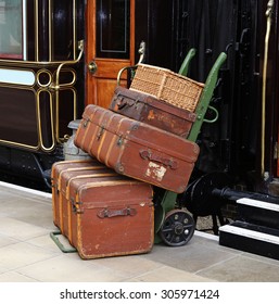 Nostalgic View Of Old Luggage And Baggage On A Platform Trolley At A Train Station In England