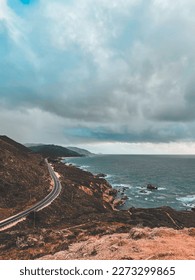 Nostalgic view of an old road winding along the rugged coastline of California, known as Road 1 or Pacific Coast Highway.