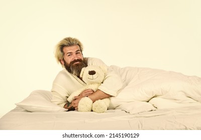 I am not alone. Cute teddy bear toy. Lovely hipster. Positive bedroom environment. Playful and romantic. Bearded hipster play toy. Man hug soft toy relaxing in bed. Good vibes. Imaginary friends