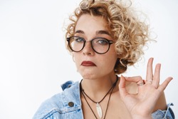 Not Bad, You Did Great. Portrait Of Impressed And Surprised Good-looking Blond Funny Woman In Glasses Pursing Chin And Looking Like Expert At Camera, Showing Okay Gesture Giving Judgemental Acception