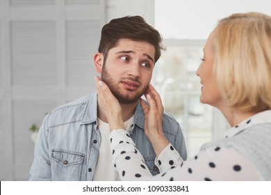 I am not a boy. Sad bearded man looking at his mother while not being happy with her attention