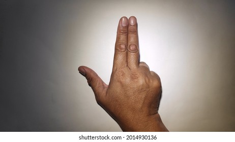 not focused. asian man right hand with two calloused fingers pointing up