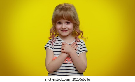 I Am Not Guilty. Portrait Of Blonde Kid Child 5-6 Years Old Pointing Fingers Himself Ask Say Who Me No Thanks I Do Not Need It. Yellow Studio Wall Background. Teenager Children Girl Lifestyle Emotions