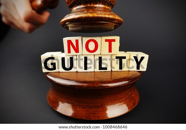 Not guilty verdict or court decision with\
judge gavel on dark\
background\
