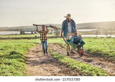 Its Not Hard Work If It Feels Like Fun. Shot Of A Mature Man Working His Adorable Son And Daughter On A Farm.