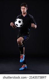 Its Not Luck, Its Skills. Shot Of A Handsome Soccer Player Isolated On Black.