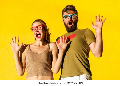 Its Not Me! Funny Couple Grimacing, Shocked And Looking At Camera. Isolated On Yellow Background, Studio Shot